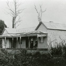 Front view of the house with Mrs Eliza Hand and a daughter on the verandah.