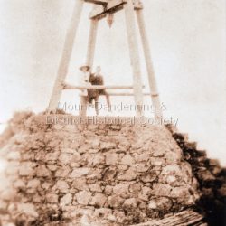 Couple seated at Mt Dandenong Trig Point. (2 copies)