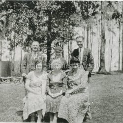 The Log Cabin Cafe was built by Jack Dodd for Miss Agnes Portelli in 1926. Miss Portelli ran the Log Cabin for many years with assistance from her niece, Evelyn Earney (nee Anstey) and other local girls. The photograph shows Evelyn Earney (LHS), Agnes Portelli (Centre) with unnamed visitors.