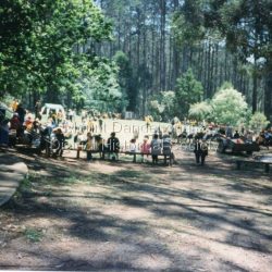 1997 was the school's centenary year. The first Mt Dandenong State School opened in a shed on the property of William Ferguson on the corner of Blythe and Old Coach Roads. The first teacher was Miss Ethel Gruber who opened the school on May 11th, 1897. It wasnt until 1901 that the school shifted over the road into an old school building that was moved up to the new site from Ringwood. All the buildings were demolished to make way for a new school that opened in 1991.: View of Sports Day November 1997 with parents watching and children participating.