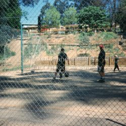 1997 was the Centenary Year of the school. The first Mount Dandenong State School opened in a shed on the property of William Ferguson on the corner of Blythe and Old Coach Roads. The first teacher was Miss Ethel Gruber who opened the school on May 11th, 1897. It wasnt until 1901 that the school shifted over the road into an old school building that was moved up to the new site from Ringwood. All the buildings were demolished to make way for a new school that opened in 1991.: Students playing on the basketball/tennis court below the school oval in 1997