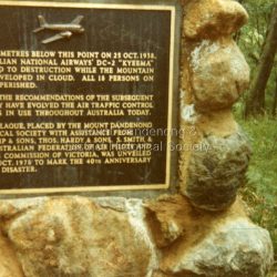 Close up photograph of the Plaque on the Kyeema cairn at Mt Dandenong. The text reads: FIFTY METRES BELOW THIS POINT ON 25 OCT. 1938, AUSTRALIAN NATIONAL AIRWAYS' DC-2 'KYEEMA' PLUNGED TO DESTRUCTION WHILE THE MOUNTAIN WAS ENVELOPED IN CLOUD. ALL 18 PERSONS ON BOARD PERISHED. FROM THE RECOMMENDATIONS OF THE SUBSEQUENT ENQUIRY HAVE EVOLVED THE AIR TRAFFIC CONTROL SYSTEMS IN USE THROUGHOUT AUSTRALIA TODAY. THIS PLAQUE, PLACED BY THE MOUNT DANDENONG HISTORICAL SOCIETY, WITH ASSISTANCE FROM G. GRAMP & SONS, THOS. HARDY & SONS, S. SMITH & SON, AUSTRALIAN FEDERATION OF AIR PILOTS AND FORESTS COMMISSION OF VICTORIA, WAS UNVEILED ON 25TH OCT. 1978 TO MARK THE 40TH ANNIVERSARY OF THE DISASTER.