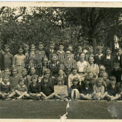 Full school photograph c1938 showing 43 pupils with Head Teacher Mr. M. F. Morris and Sewing Teacher (female).