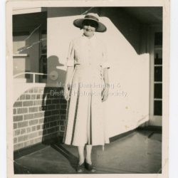 Miss Bell (1900 1984) The Miss Bell Playground at Mount Dandenong Primary School was named after Miss Rebecca Adelaide Bell, a retired teacher who regularly helped out at Mount Dandenong Primary school from 1978 - 1984. Miss Bell grew up in an Anglican orphanage in Queensland and became a teacher, working in South Australia and Victoria. Miss Bell had fond memories of holidays spent at Mountjoy in the Dandenong Ranges. When she retired Miss Bell built a home in Jeeves Avenue where she lived out the rest of her life with her Siamese cats. Miss Bell helped the children with reading, grammar spelling and history. She really cared about the children and her school visits brought her a lot of happiness.: Black and white photograph of a woman wearing a large hat taken in front of a building.