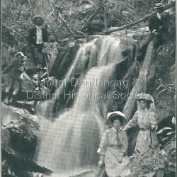 Photograph from the Dower family collection taken of the Upper Olinda Falls in the early 1900s. The two men, two women and young boy are all well dressed and posing for a photograph.: Black and white photograph received as a jpeg digital image 576KB showing two womwn, two men and a boy at the Olinda Falls early 1900s.: On front of image: Early 1900s Olinda Falls at Mount Dandenong