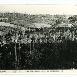 View from Ridge Road, Mount Dandenong. taken from near exit road from observatory. Looks towards Olinda on right skyline with Church of England just below it. In middle of picture on the extreme right can be seen the Dulce Domum hotel with Mitlan's white house just left above it. Taken about 1920. Road going up right from centre of picture is Dicken's road going up to the main road at what is now 'buggy wheels corner'
Handwritten inscription on reverse by John Lundy-ClarkeView from Ridge Road, Mount dandenong. taken from near exit road from observatory. Looks towards Olinda on right skyline with Church of England just below it. In middle of picture on the extreme right can be seen the Dulce Domum hotel with Mitlan's white house just left above it. Taken about 1920. Road going up right from centre of picture is Dicken's road going up to the main road at what is now 'buggy wheels corner'