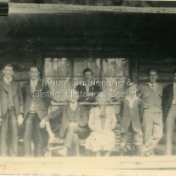 Posed photograph taken on verandah of house showing Jack Dodd with his wife and sons. Reverse of photograph has handwritten description by John Lundy-Clarke.: Jack Dodd of Olinda, Wife and their sons.