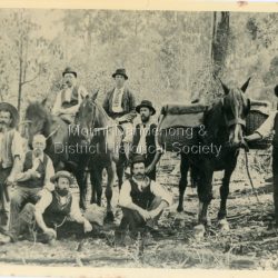 Group photo of pioneer settlers of Olinda. Jack Dodd is shown RHS holding the rein of his packhorse 'Darkie". The descriptive text on the reverse of this photograph was hand written by John Lundy-Clarke.: Pioneer settlers of Olinda. Jack Dodd with the packhorse.