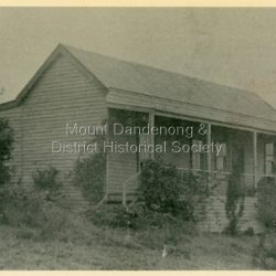 Front view of 'Hillcrest' the Devine family home on Mernda Road, Olinda taken in 1911. The road deviation passed to the right of where the photographer was standing. The descriptive text on the reverse of this photograph was hand written by John Lundy-Clarke.: Hillcrest the home of the Devine family 1911 in Mernda Road now Coonara Road. The road was deviated here to regrade it and the deviation past to the right of the camera. The house fronted down over the valley of the Sassafras Creek towards Kallista. It was close to the spot where the camera stood that the girls practiced the maypole dance in 1911. Vera Devine trained 11 of her mates in the dance here.
