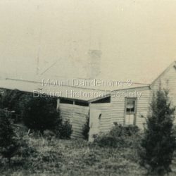 "Hillcrest" on Mernda Road, Olinda. The home of the Devine Family. c1911 The descriptive text on the reverse of this photograph was hand written by John Lundy-Clarke.: Hillcrest Mernda Road Olinda 1911. The home of the Devine family. The early settlement road passed to the left of the camera. House faced down over the valley of the Sassafras + Perrin Creek towards Kallista. The deviation to regrade the road passed to the right of the house. It was in front of the house on the left hand side of the picture that Vera Devine and her school mates practiced the maypole dance under her tuition.
