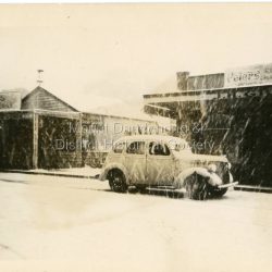 c1950 Snow scene in Main Street Olinda with old car parked outside the store of J.H. Gill.