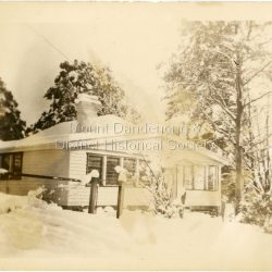 View of a newly built house at Olinda under snow c1950.