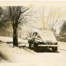 Snow scene in Main Street Olinda opposite shops c1950. Old taxi shown waiting at Taxi rank.