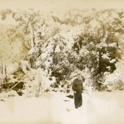 Heavy snowfall at Olinda c1950. Unknown person standing in snow.