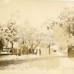 Snow scene at Olinda c1950 showing people in snow and old car.