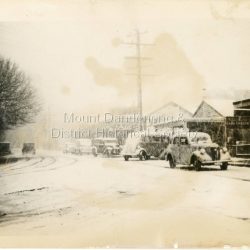 Cars and small bus in Main Street Olinda during heavy snow c1950.