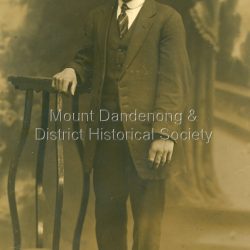 Peter Johnston was the boyfriend of Iris Dorey, a daughter of the pioneering Dorey family. Iris ran the Quamby Cafe (now Cuckoo Restaurant) and later in life married Ted Woolrich from Woolrich Nursery. Peter was killed on active service during WW1 on May 15th 1918. Alice Dorey was the sister of Iris.: Black and white studio photograph of Peter Johnston. Photograph is in postcard format made by R Yeoman 116 Bourke Street Melbourne.: Handwritten on back: To Alice with love From Peter 18/3/14