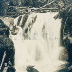 Copy of a postcard labelled Lower Olinda Falls. There is an original postcard in the collection depicting the same image but with a young man sitting on a rock upper LHS. That postcard identifies the area as Upper Olinda Falls - which is correct. Printed on front: Lower Olinda Falls. In Erasmus B Allen's tourist guide of 1904, these falls are described as Olinda Falls 2nd Leap which may explain the discrepancy with the very similar photo that describes these as the upper falls.