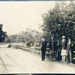 Three women and two men standing on a bridge, location unknown. Clothes are 1920s.Members of Dorey or Woolrich families.