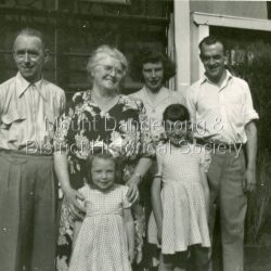 Group of two men, two women and two young girls posed outside the front of the Quamby Café at Olinda c1950s. Group of two men, two women and two young girls posed outside the front of the Quamby Café at Olinda c1950s.