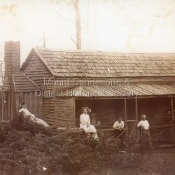 Family group outside a house