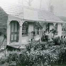 Three men outside a house