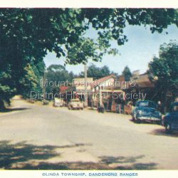 Main street of Olinda.
Caption on reverse reads: A delightfulscenic gem situated 20 miles from Melbourne, the Dandenong Ranges provide a medley of beautiful Fern Gullies, Forests, Colourful Gardens and Wide Panoramas equal to the World's best.