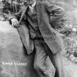 C. Web Gilbert leaning on a rock