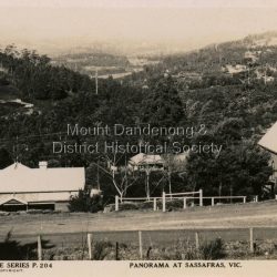 This set of small photographs was produced by the Rose Stenograph Co. c1913 to be included in photograph albums. The 1913 date cannot be correct becasue of the cars visible in and the fact that electricity arrived in 1927. The area known as South Sassafras, was opened up for settlement in 1893 and the name was changed to Kallista in 1925.
A small, paper envelope containing 12 photographs of Sassafras that are reproductions of Rose Series postcards. There are 10 different photographs, SAS0032-01and SAS0032-03 have doubles.
Envelope: Beauty Spots in Australia 12 Real Photographs For Your Snapshot Album Published by the Rose Stenograph Co. Rear 17 Auburn Grove, Armadale, Vic S.E.3 SASSAFRAS, VICTORIA
Photograph SAS0032-01 - The Rose Series P. 905: Clematis Avenue, Sherbrooke, Vic
Photograph SAS0032-02- The Rose Series P. 1603: The Cascades, Sassafras, Vic
Photograph SAS0032-03- The Rose Series P. 204: Panorama at Sassafras, Vic
Photograph SAS0032-04- The Rose Series P. 4046: Main Road, Sassafras, Vic
Photograph SAS0032-05- The Rose Series P. 1502: Sassafras Creek, Sassafras, Vic
Photograph SAS0032-06- The Rose Series P. 1501: Tourist Track, Sassafras, Vic
Photograph SAS0032-07- The Rose Series P. 4244: Tourist Track, South Sassafras, Vic
Photograph SAS0032-08- The Rose Series P. 2725: Clematis Avenue, Sherbrooke, Vic
Photograph SAS0032-09- Main Road, Sassafras, Vic
Photograph SAS0032-10- The Olinda - Sassafras Road, Vic