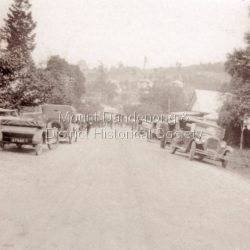 A large number of cars parked outside the Mechanics Institute in the Main Street of Sassafras during the visit of Edward, Prince of Wales in 1920.: Copy of a black and white photograph depicting old cars lining the Main Street of Sassafras 1920.
Cutting from the The Maitland Weekly Mercury (NSW : 1894 - 1931)Saturday 5 June 1920
The Prince of Wales spent Sunday afternoon and evening quietly with the Prime Minister (Mr. Hughes) and Mrs. Hughes. An enjoyable drive to Sassafras after, lunch with the Prime Minister and two members of his staff came as a welcome break after the arduous round of functions and ceremonies.
When the members of the purty arrived at Mr. Hughes' mountain home, Sassafras, they went for a two hours' ride on horse back through undulating hills and rugged gullies. Tho fern-clad forests of the Dandenong Ranges were a fine spectacle. The party travelled from the mountain, down through Monbulk. Although the roads in the gullies were muddy, the main road was dry and in good condition, and the Prince had an opportunity of , enjoying an exhilarating gallop.
The Prince, whose fondness of horses is well known, is an accomplished rider. The party halted to 'boil the billy.' The Prince was delighted with his introduction to this special feature of an Australian, picnic. The scene of the Informal meal was set in a pretty meadow in the gully.
While at Sassafras the Prince was presented with a live wallaby, the gift of a young lady, whom he graciously thanked.
The Prince motored with Mr. Hughes to his home in Kew, where he was the guest of the Prime Minister at dinner, and returned to Government House in the evening, spending it quietly.
Cutting from the Sunday Times (Sydney, NSW : 1895 - 1930)Sunday 6 June 1920
The Wallaby Has to Jump
The wallaby presented to the Prince of Wales at Sassafras the other day is providing him with a little relaxation. Out at Federal Government House he has had a tittle hurdle set up, and spends all his off moments gravely putting the pet through a series of tricks, including jumping lessons. What the wallaby thinks about the pastime nobody has yet ascertained.
